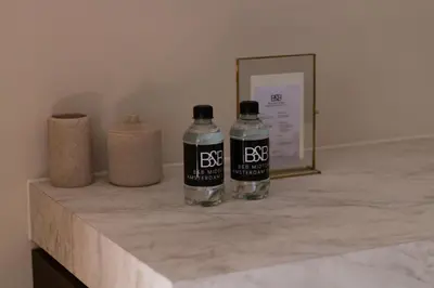 two bottles of water sitting on top of a counter at B&B Midtown Amsterdam suites in Amsterdam