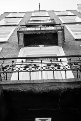 a building with a balcony on top of it at Hotel D'Amsterdam Leidsesquare in Amsterdam