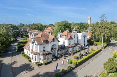 an aerial view of a town with white houses at Amrâth Hotel Media Park Hilversum in Hilversum