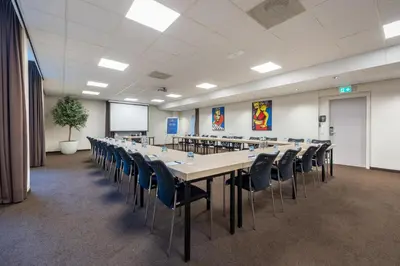 a large conference room with a long table and chairs at Amrâth Hotel Media Park Hilversum in Hilversum