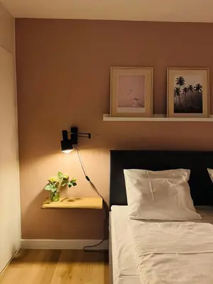 a bedroom with a bed and a table with a lamp at Hello Noordwijk - Souterrain Hoogwakersbosstraat 6 in Noordwijk aan Zee