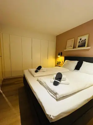 a hotel room with two beds with hats on them at Hello Noordwijk - Souterrain Hoogwakersbosstraat 6 in Noordwijk aan Zee
