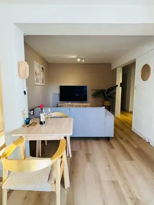 a living room with a table and chairs and a couch at Hello Noordwijk - Souterrain Hoogwakersbosstraat 6 in Noordwijk aan Zee