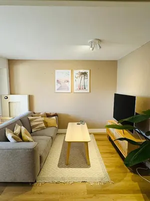 a living room with a couch and a coffee table at Hello Noordwijk - Souterrain Hoogwakersbosstraat 6 in Noordwijk aan Zee