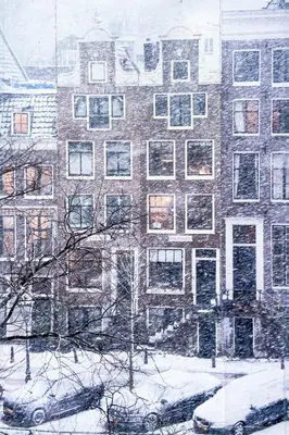 a painting of a building in the snow at JoyJoyJoy the Green Palm ecolicious studio in a in historic Canalhouse from 1729 with view on the canals in Amsterdam
