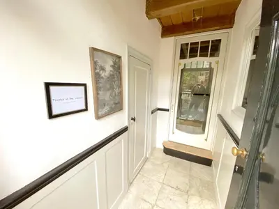 a hallway with a door leading into a room at JoyJoyJoy the Green Palm ecolicious studio in a in historic Canalhouse from 1729 with view on the canals in Amsterdam