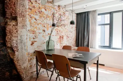 a dining room with a black table and chairs at Hotel IX Nine Streets Amsterdam in Amsterdam