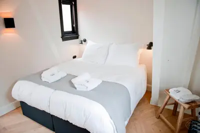 a bedroom with a bed with two towels on it at Hotel IX Nine Streets Amsterdam in Amsterdam