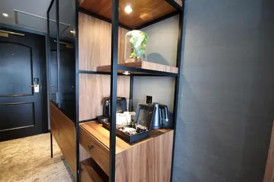 a room with a tv on a wooden wall at Alexander Hotel in Noordwijk aan Zee