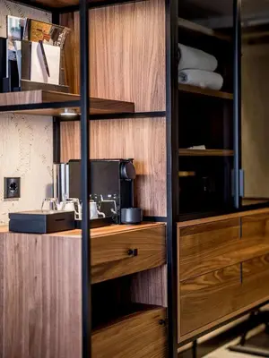 a kitchen with wooden cabinets and a sink at Alexander Hotel in Noordwijk aan Zee