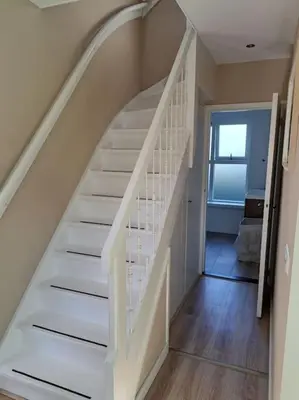 a white staircase in a home with a window at Family House Wakker in Eemnes