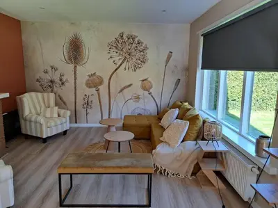 a living room with a couch and a table at Family House Wakker in Eemnes