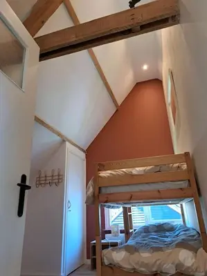a bedroom with a bunk bed in a attic at Family House Wakker in Eemnes