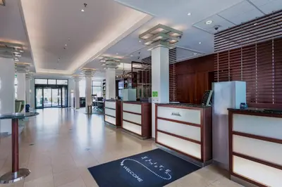 a lobby of a store with a row of counters at Courtyard by Marriott Amsterdam Airport in Hoofddorp
