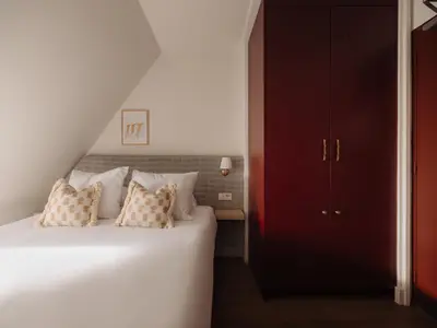 a bedroom with a bed and a red cabinet at Adam's Museum House in Amsterdam