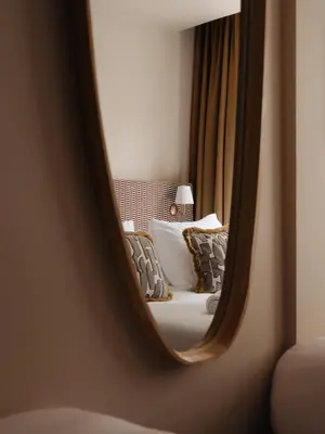 a mirror reflection of a bed in a room at Adam's Museum House in Amsterdam