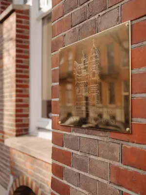 a picture of a building on a brick wall at Adam's Museum House in Amsterdam