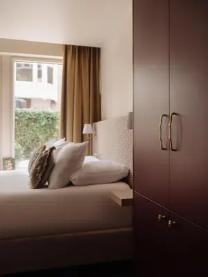 a bedroom with a bed with pillows and a window at Adam's Museum House in Amsterdam