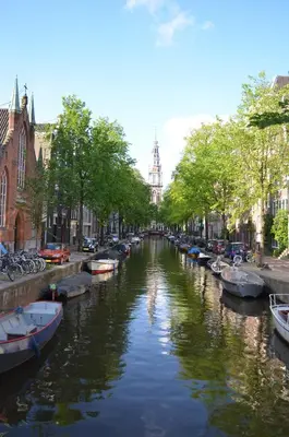 a river with boats parked on the sides of it at Rembrandtplein Bed & Breakfast in Amsterdam