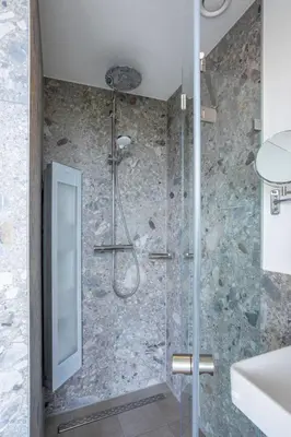 a bathroom with a shower with a glass door at Holiday Home Putter Comfort by Interhome in Noordwijk