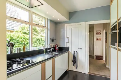 a kitchen with a sink and a counter top at Huize Nassau in Bergen