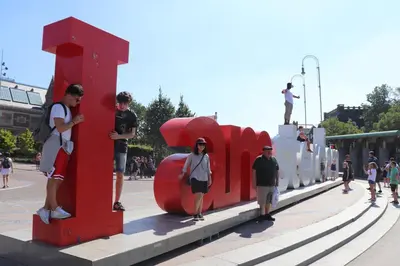 a group of people standing next to a red sculpture at Amsterdam Hostel Annemarie in Amsterdam