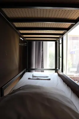 a bed in a room with a window at Amsterdam Hostel Annemarie in Amsterdam
