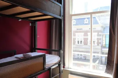 a bunk bed in a room with a window at Amsterdam Hostel Annemarie in Amsterdam