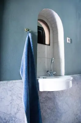 a bathroom with a sink and a blue towel at Amsterdam Hostel Annemarie in Amsterdam