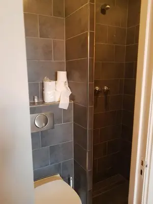a bathroom with a toilet and a shower at Amsterdam Hostel Annemarie in Amsterdam