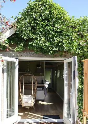 an open door with a plant growing on top of it at 1 for 2 in Nederhorst den Berg