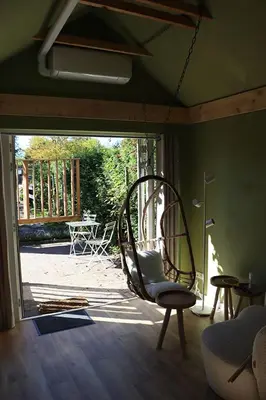 a room with a chair in a room with a patio at 1 for 2 in Nederhorst den Berg