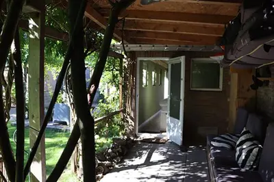 a porch of a house with a door open at 1 for 2 in Nederhorst den Berg