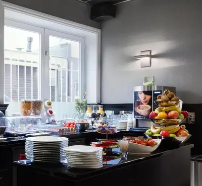 a kitchen with a table with plates of food at Hotel Luxer in Amsterdam