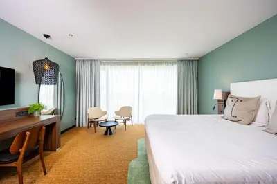 a hotel room with a bed and a desk at Van der Valk Hotel Schiphol in Hoofddorp