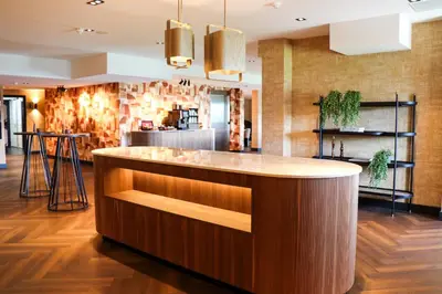 a kitchen with a wooden island in a room at Van der Valk Hotel Vianen - Utrecht in Vianen