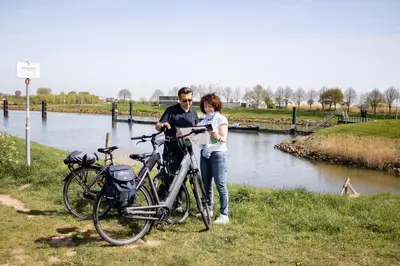 a man and a woman standing next to their bikes at Van der Valk Hotel Vianen - Utrecht in Vianen