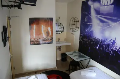 a room with a poster on the wall and a table at Bicycle Hotel Amsterdam in Amsterdam