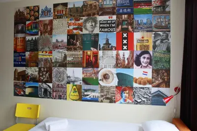 a collage of pictures on a wall in a bedroom at Bicycle Hotel Amsterdam in Amsterdam