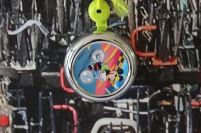 a pocket watch is hanging on a wall with graffiti at Bicycle Hotel Amsterdam in Amsterdam