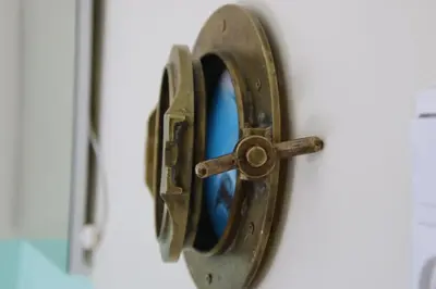 a bronze door knocker on a door with a mirror at Bicycle Hotel Amsterdam in Amsterdam