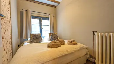 a bedroom with a bed with towels on it at Locatie Downtown in Amsterdam