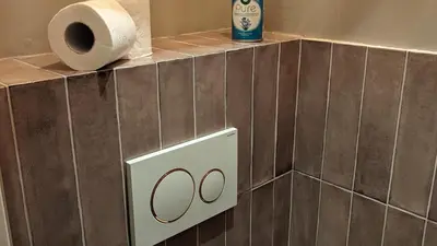a toilet paper dispenser with a roll of toilet paper at Locatie Downtown in Amsterdam