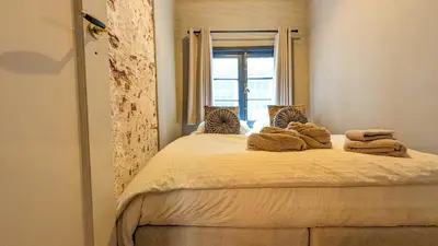 a bedroom with a bed with towels on it at Locatie Downtown in Amsterdam