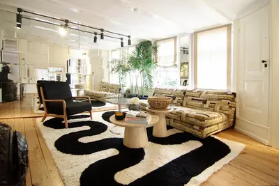 a living room with a couch and a table at Exceptional Stay in Jordaan Area in Amsterdam