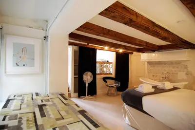 a bedroom with a bed and a chair in a room at Exceptional Stay in Jordaan Area in Amsterdam