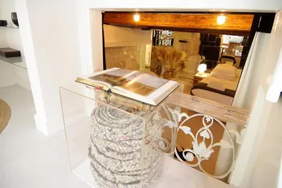 a glass vase with a book on top of it at Exceptional Stay in Jordaan Area in Amsterdam