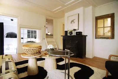 a living room with a table and a fireplace at Exceptional Stay in Jordaan Area in Amsterdam