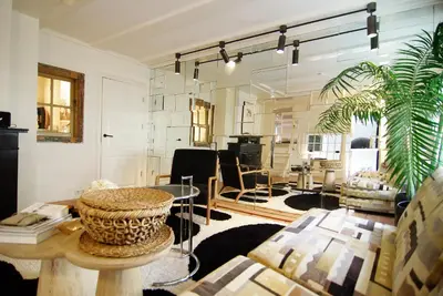 a living room with a table and a couch at Exceptional Stay in Jordaan Area in Amsterdam