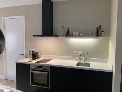 a kitchen with a sink and a counter top at The Oyster House With Private Parking in Zandvoort
